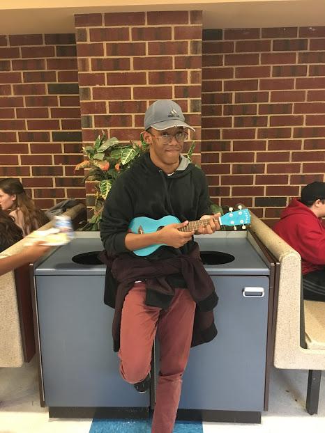 Michael Haynesworth playing his ukulele in the cafeteria.