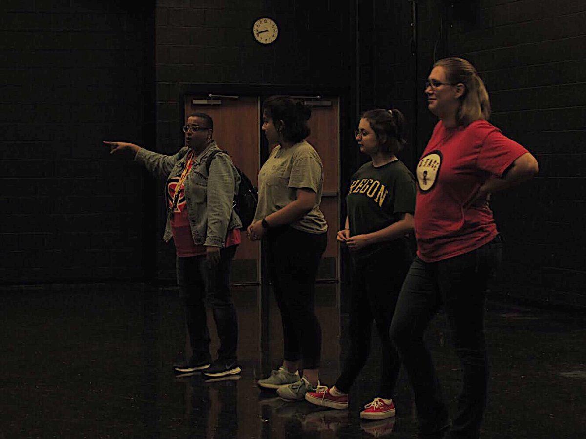 Director Lily Jones, Student Director Jasselene Paz, Stage Manager Phoebe LaMountain, and Executive Producer Hope Bachman give instructions to the cast of Noises Off. Shows begin on November 9. 