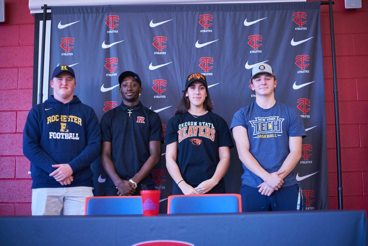 Titans+celebrating+their+years+of+hard+work+by+signing+to+contiune+playing+their+sport+in+college