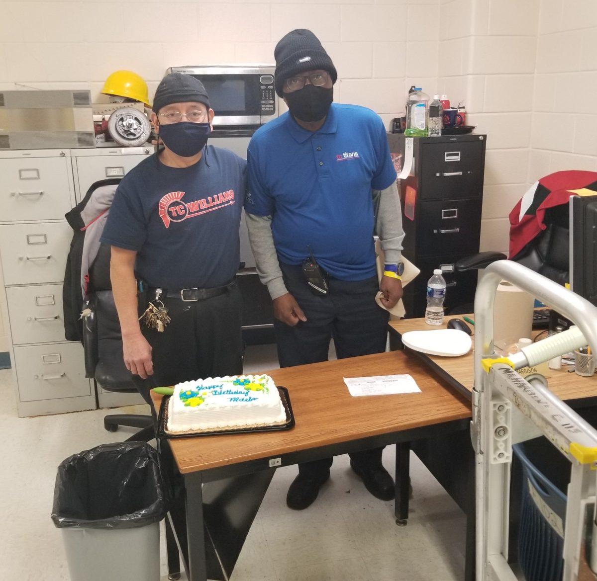 Mario Yach (left) and James Harrison (right) before cutting slices of cake to celebrate Yachs 60th birthday. 