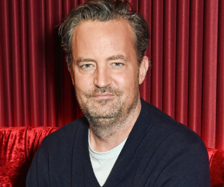 Matthew Perry sits in front of a red velvet background for People magazine / David M. Benett / Getty Images