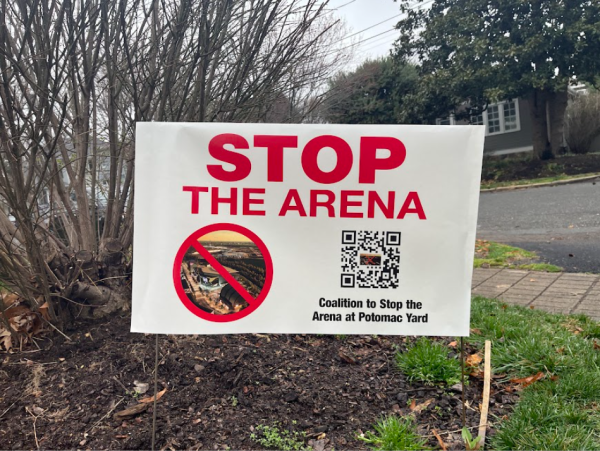 A yard sign says "stop the arena."