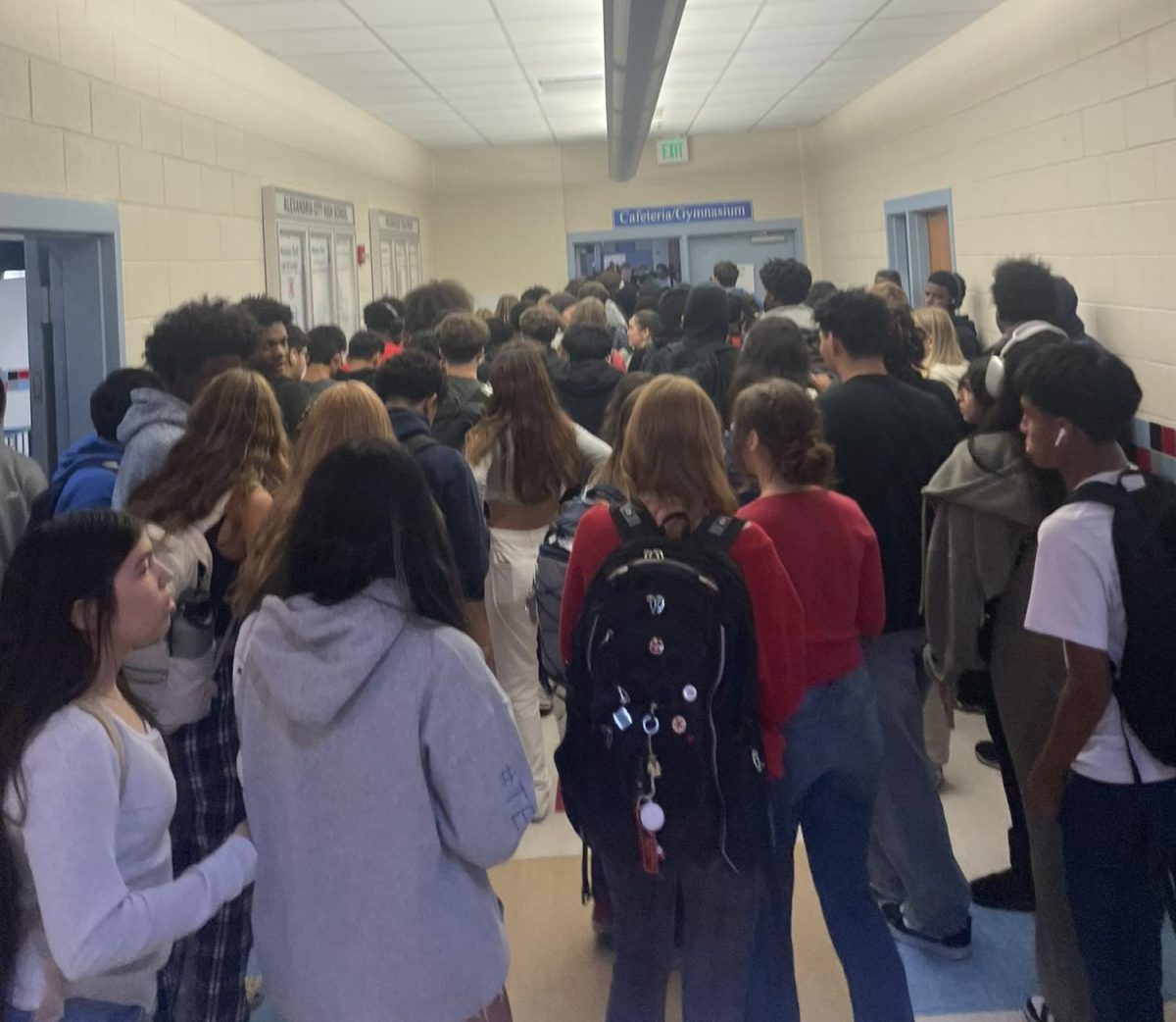 Six minutes after lunch started, the line to enter the cafeteria remains long, as students are now required to scan in with Minga digital IDs. 