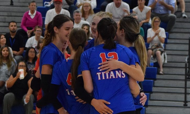 The Varsity Girls Volleyball team celebrating an Ace. 