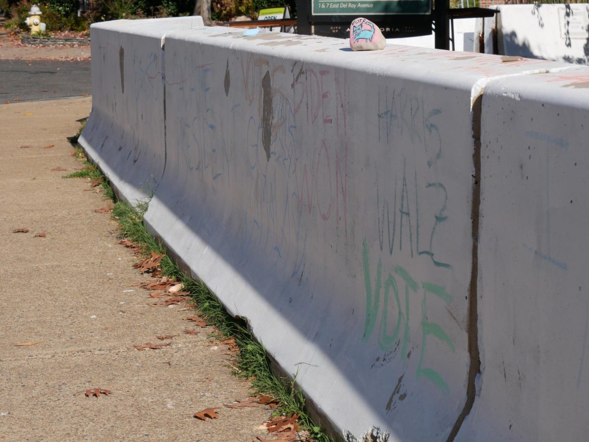 Chalk messages in support of the Democratic presidential ticket decked barriers outside of Republican Vice Presidential Candidate J.D. Vance's home in Del Ray.