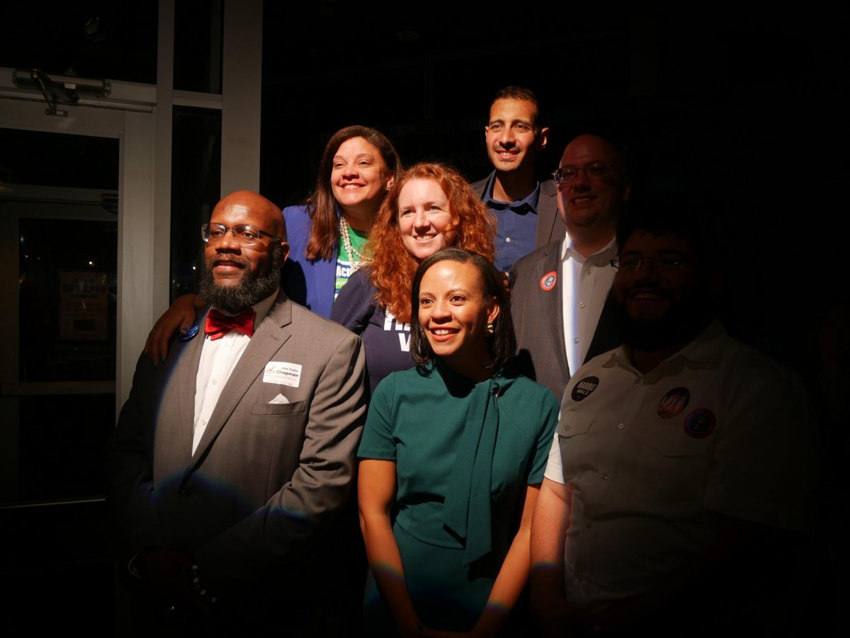 The newly elected Democratic candidates for City Council celebrate their victory at Pork Barell BBQ in Del Ray. From left: John Chapman, Jacinta Greene, Sarah Bagley, Alyia Gaskins, Abdel Elnoubi, Kirk McPike, Canek Aguirre.