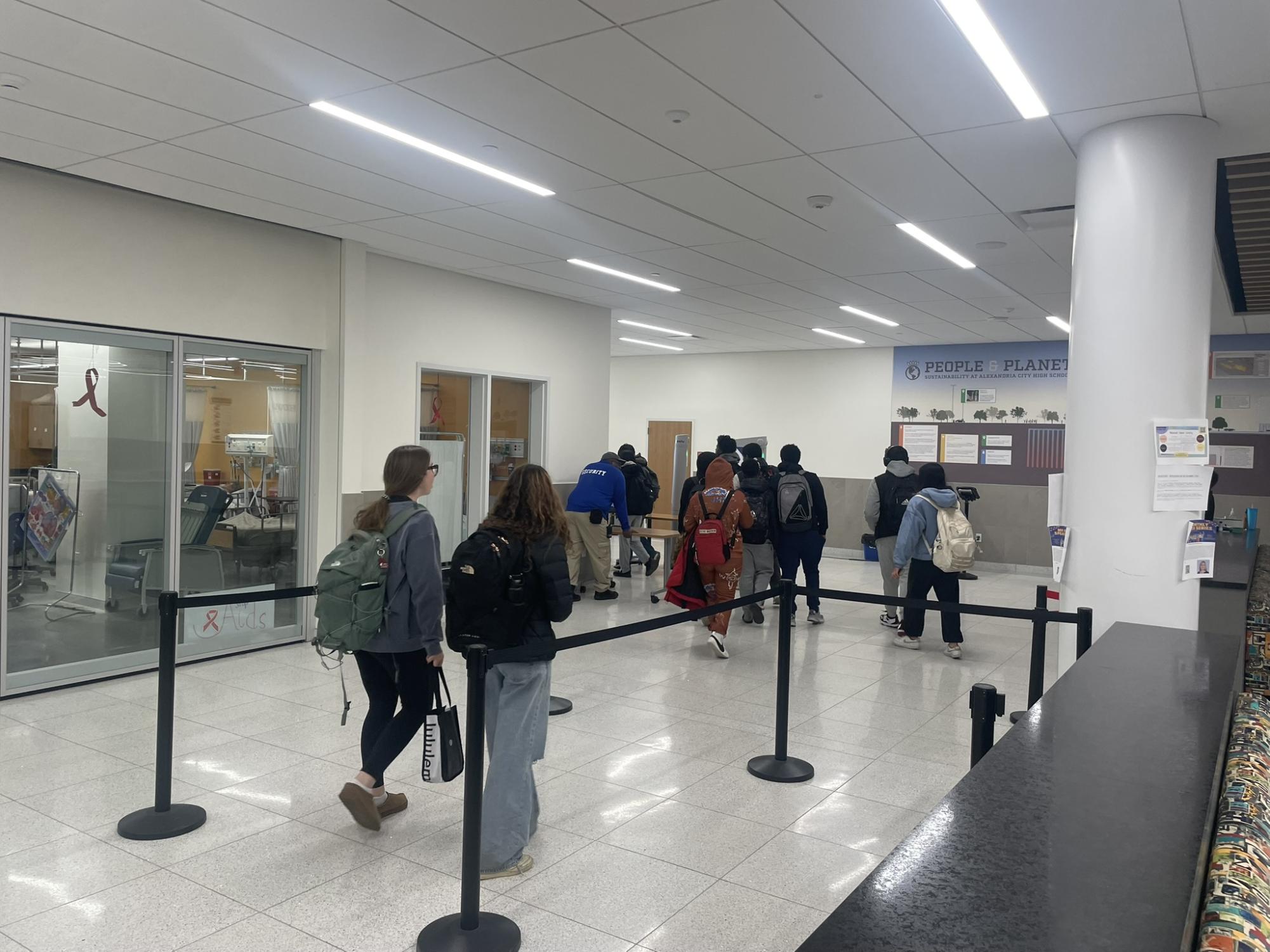 Students walk to the exit at the Minnie Howard campus. There is a very small crowd of students, and movement is free-flowing.