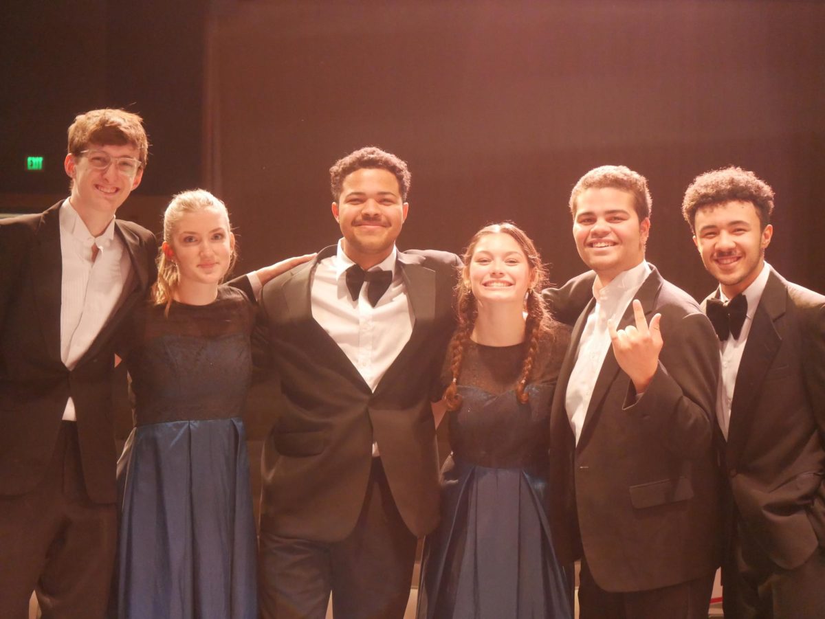 Alexandria City High School Advanced Honors Choir seniors smile for photos after the concert. From left: Patrick Osterman-Healy, Caroline Legere, Julian Ambrose, Lola Jeanne Carpio, Malcom Myrick, Legend Barnes. 