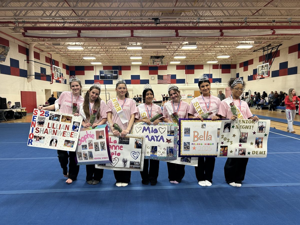 Senior gymnasts pose for a farewell photo.