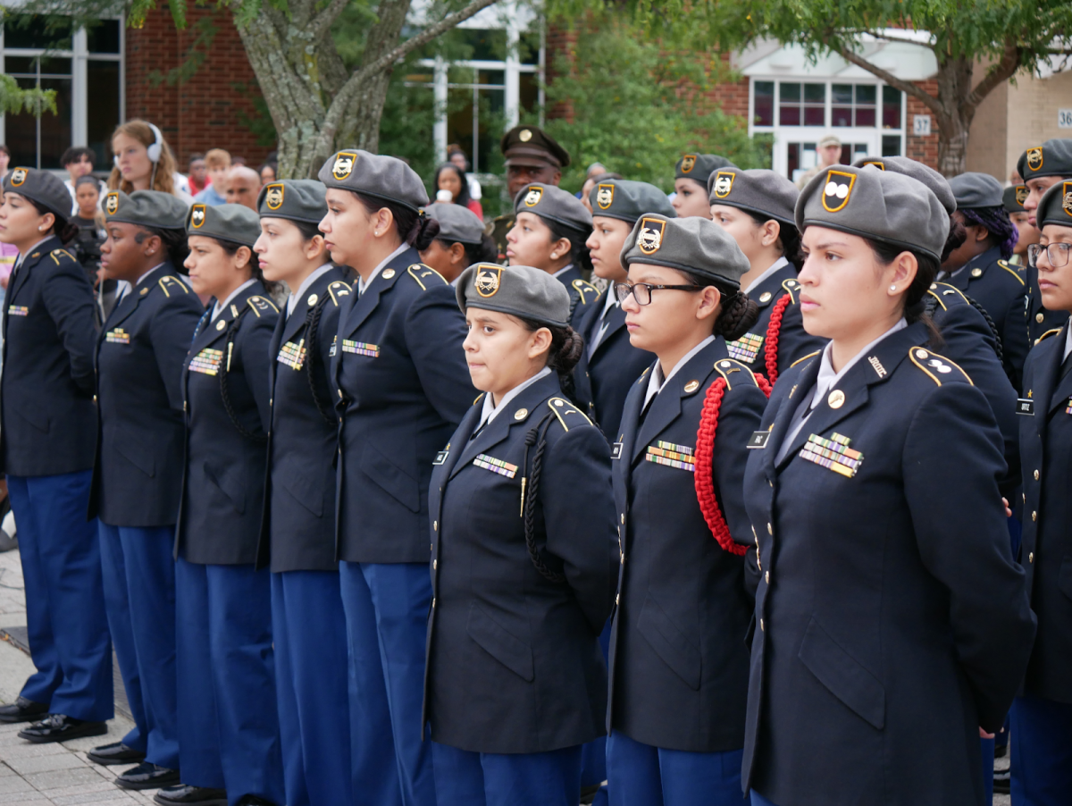 JROTC members stand front row at attention. From left: Julianna Valladares, Moriah Womack, Kymberlyn Santos, Madeline Barrientos, Emely Hernandez, Victoria Angel, Sandra Amaya, Shirlen Rac. 
