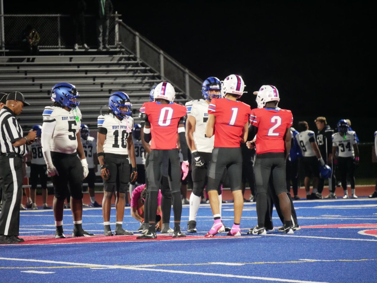 Titans and Wolverine team captains await the coin toss.