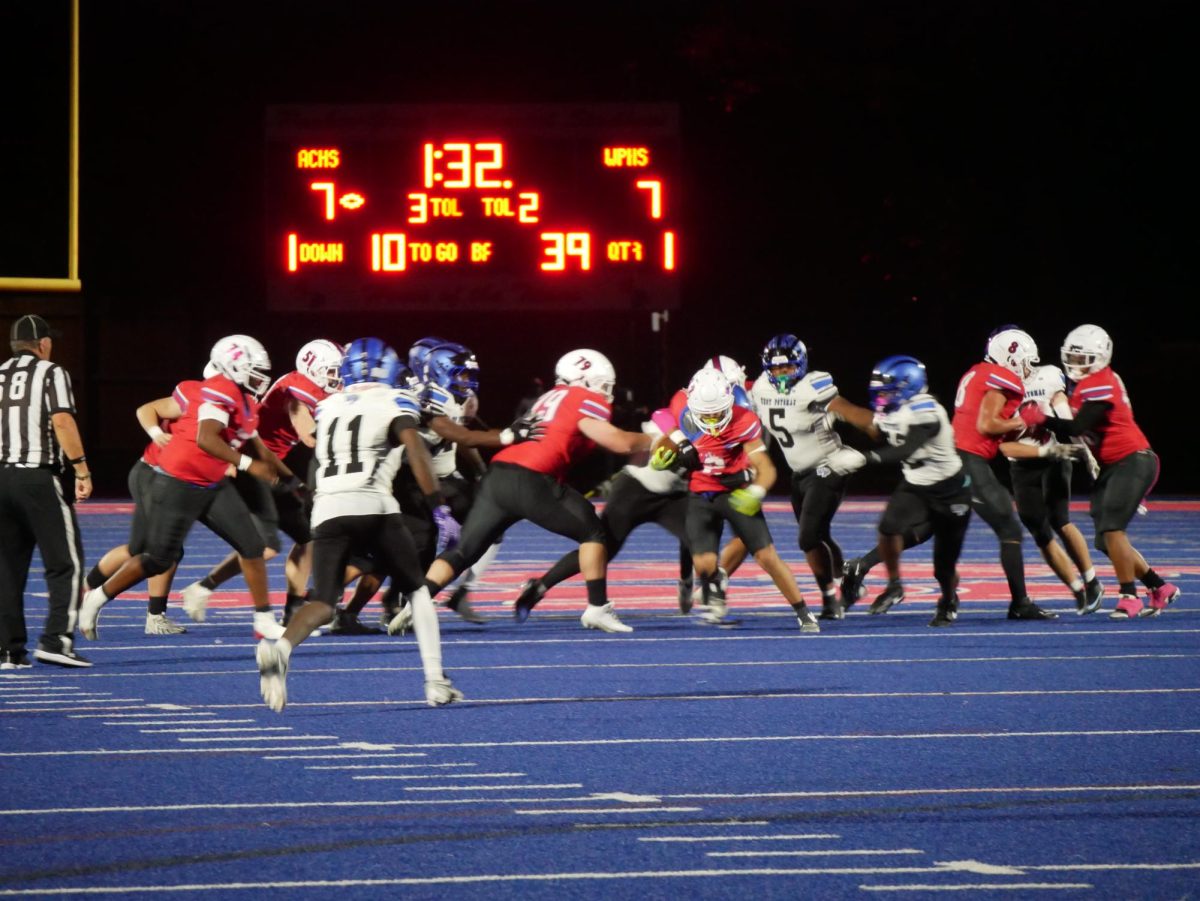 Quarterback Alpha Jalloh carries the ball through West Potomac's defensive line in the first quarter.