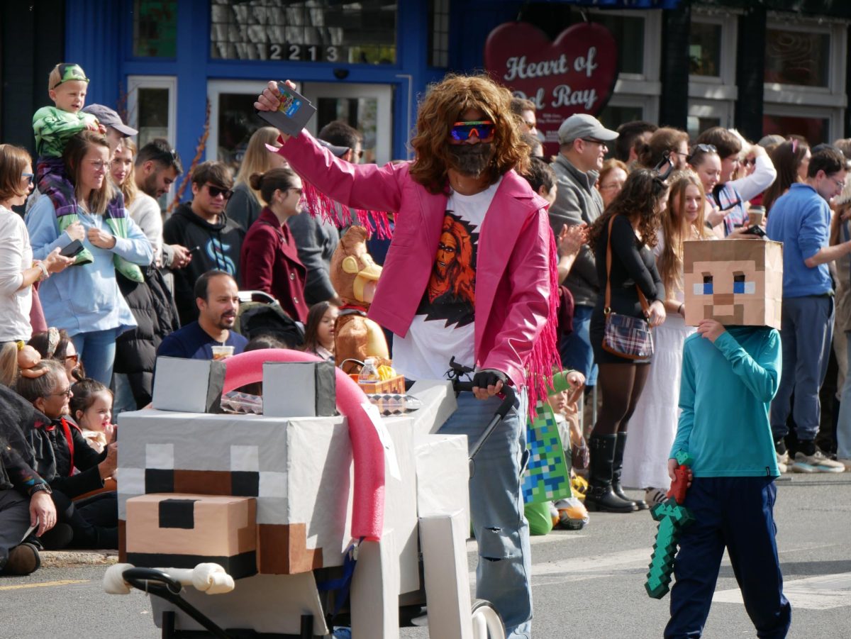 A group of contestants for the Stroller Competition join the parade as Garett Garrison and Steve from the Minecraft Movie.