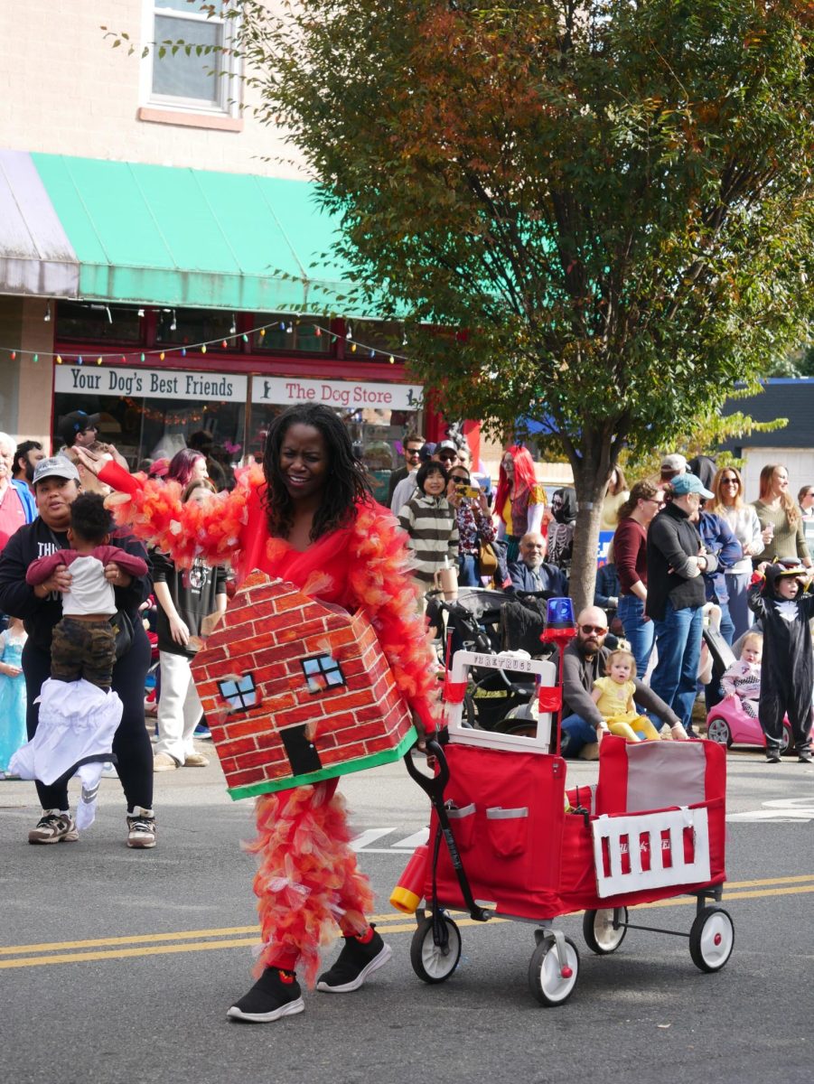 The parade also featured a stroller costume competition, with this contestant dressed as a house on fire, followed by a fire truck.
