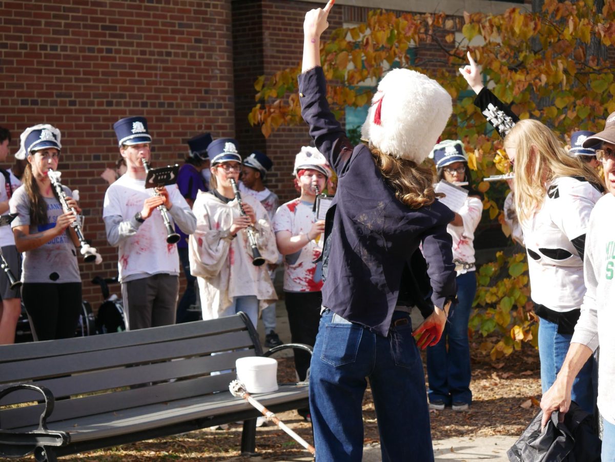 The ACHS "zombie"marching band performs in front of Mount Vernon Community School, showcasing their music to the community.