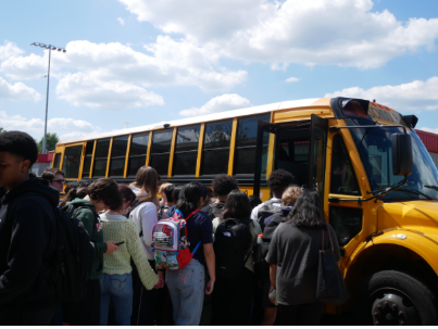Students outside the King Street Campus crowd around a bus bound for Minnie Howard.