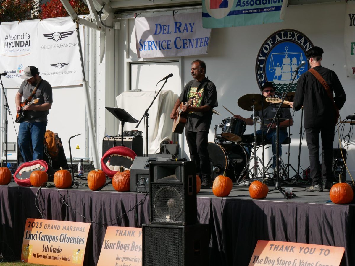 A local band performs music outside Mount Vernon Recreational Center on the field for the community.