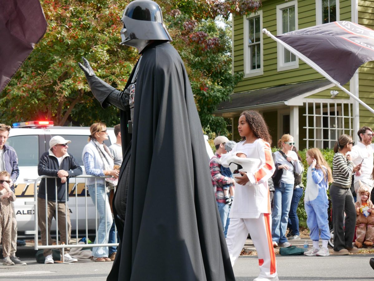 Darth Vader follows a group of Jedis as a part of a group dressed as the Star Wars cast.