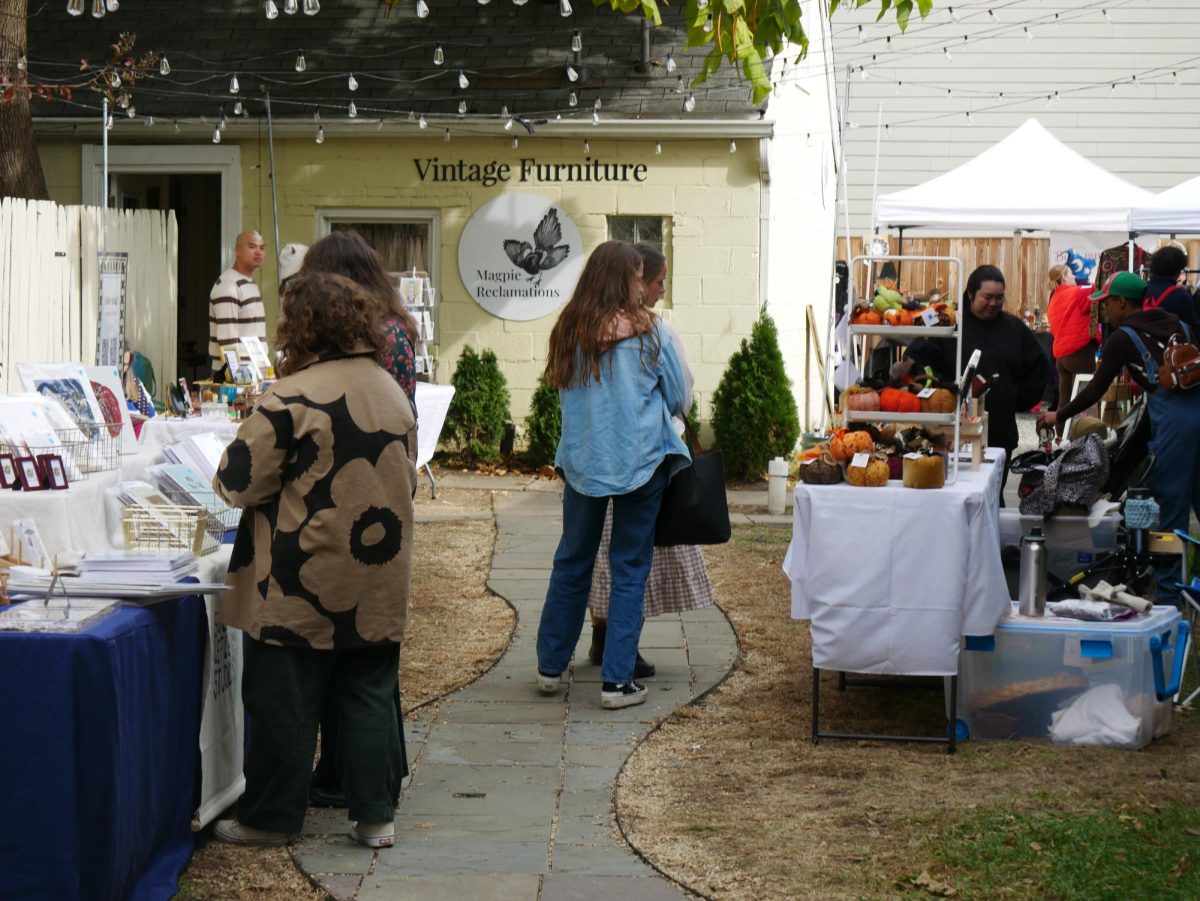 Vendors such as Susan Lefler Studios, Everything Elise and Claudia Jellett share their items with community members before the parade starts.