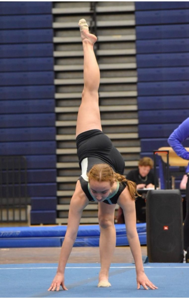 Senior Laela Ferrick on the competitive girls gymnastics team shows off her impressive floor routine at a gymnastics competition in 2024. 