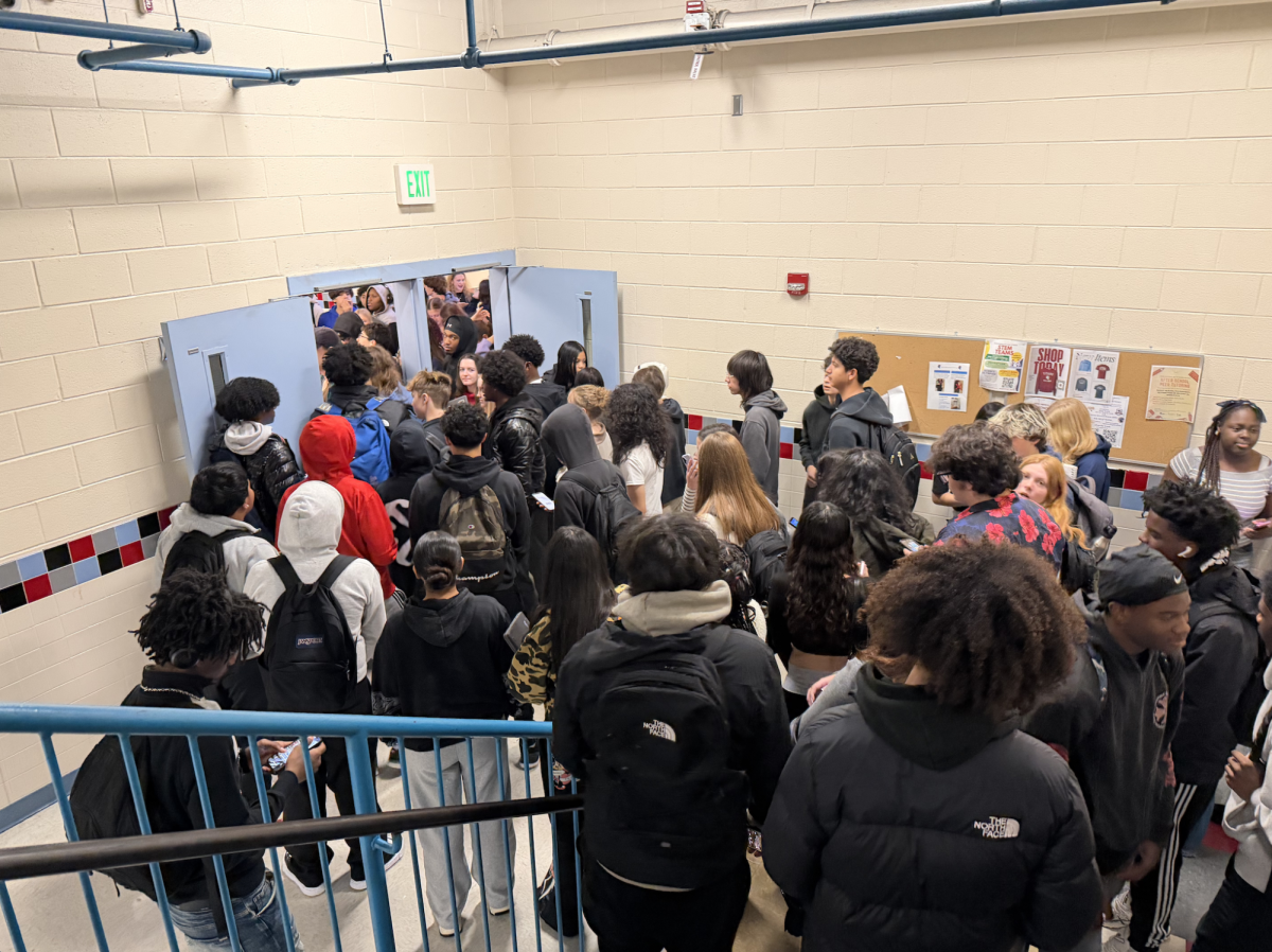 Students heading to lunch crowd the stairwells as they wait to scan their Minga.