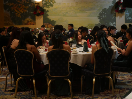 JROTC cadets sit at their assigned tables waiting for the ball to officially begin with the presentation of the Colors and the National Anthem.