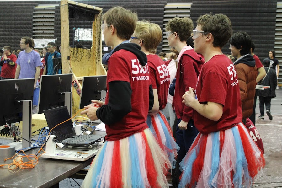 The Alexandria City High School Titan Robotics drive team attentively controls their robot, with calculated movements to help them compete against other teams to get the most points. 