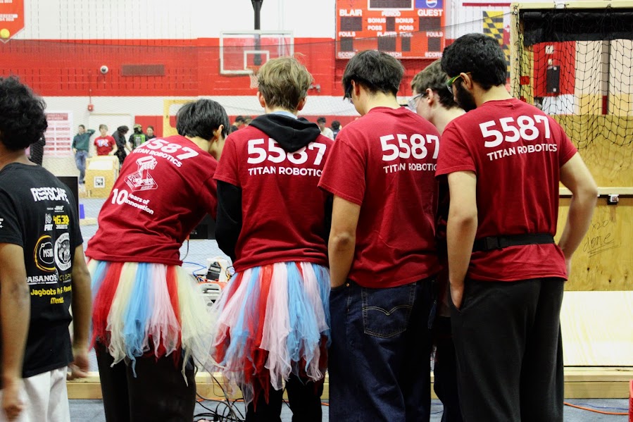 Yoon, Watkins, Rahmatullah and senior Sebastion Lov from the Titans technical team lined up behind the robots drive station, showing off their tradition of wearing team tutus whenever they are at competitions. This is where they control the robot and make all the game-changing decisions during the matches. 
