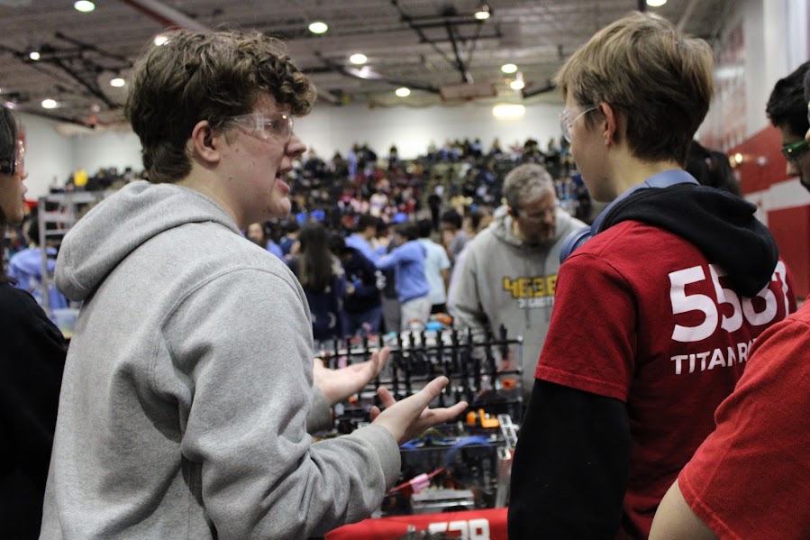 Sophomore Henry Watkins talking strategy with a student member of Jagbots Robotics from Northwest High School. After Titan Robotics selected the Jagbots as their alliance team, they had to coordinate how they were going to work together in the final rounds. 

