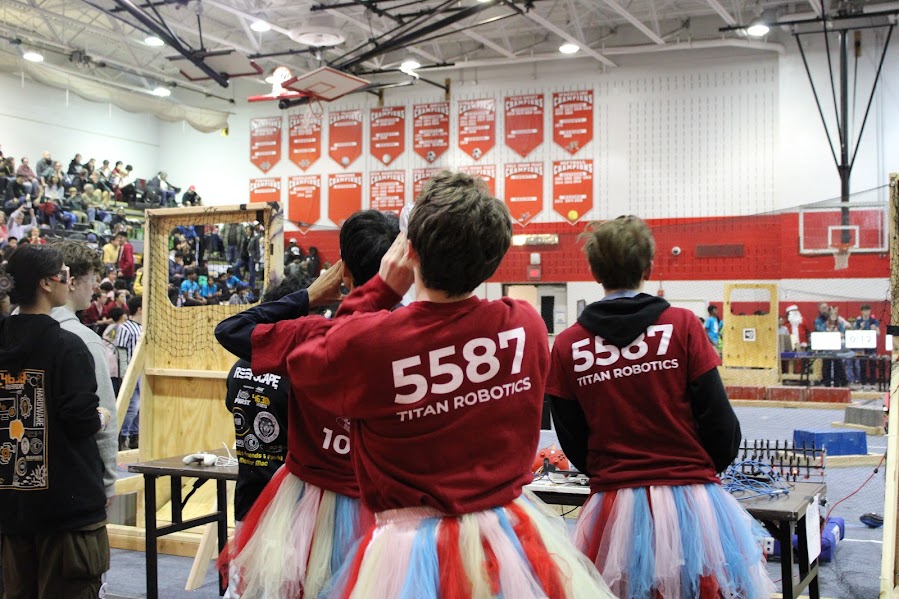 Sophomore Alex Yoon and Senior Ricky Ward lead the team in chant. This chant begins with someone, in this case it was Yoon and Ward, shouting “fifty-five” and the others in the stands responding  ‘eighty-seven.” 5587 is the Titan Robotics team number, and it represents the team in almost everything they do!