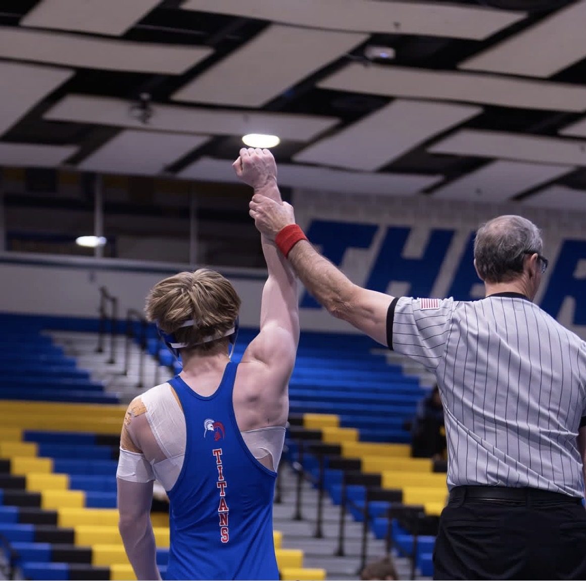 Official holds up Ryan Pyke's hand in victory after winning match