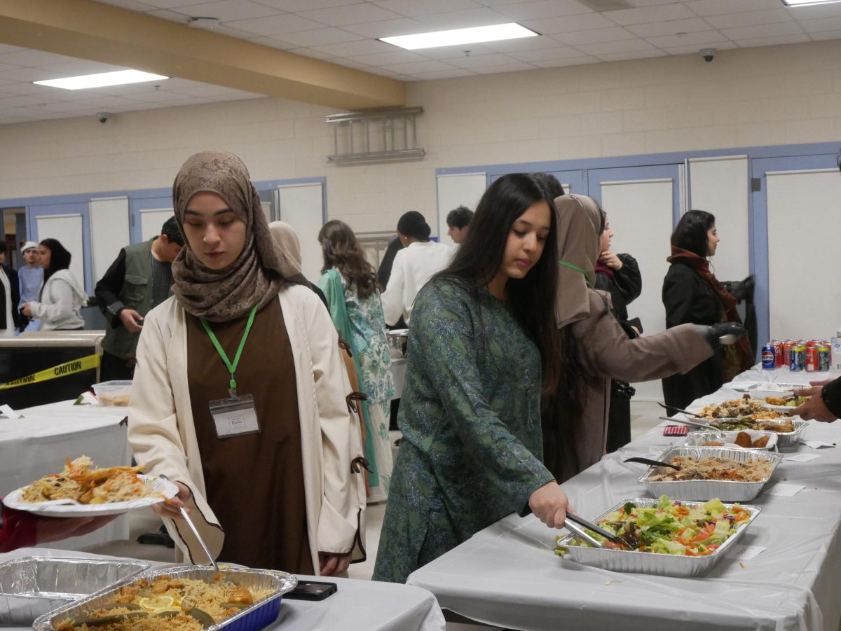 Community members gather to break the days fast, filling their plates with homemade food.