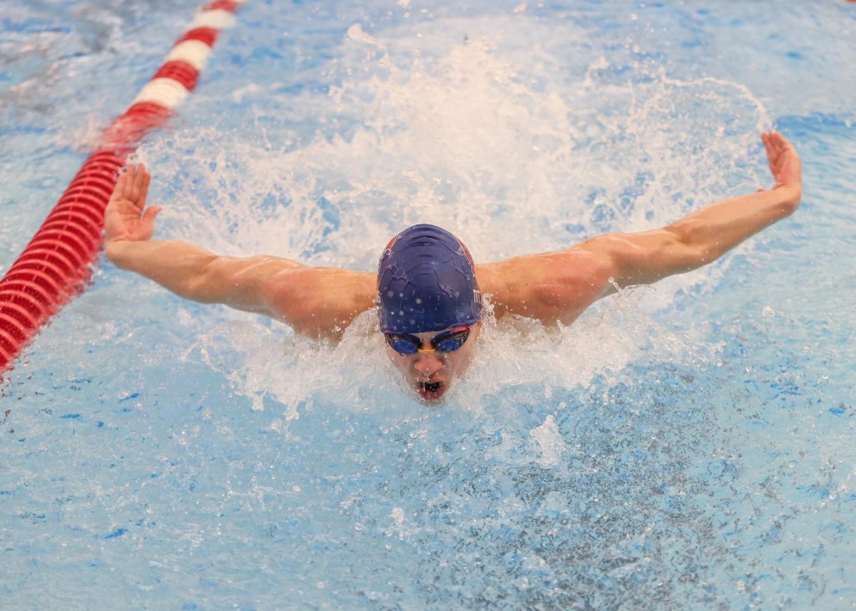 Tobias Damico-Lassman swimming the 100-yard butterfly at the state championship meet. Photo by Anna Jaeger, courtesy of John Gullickson.