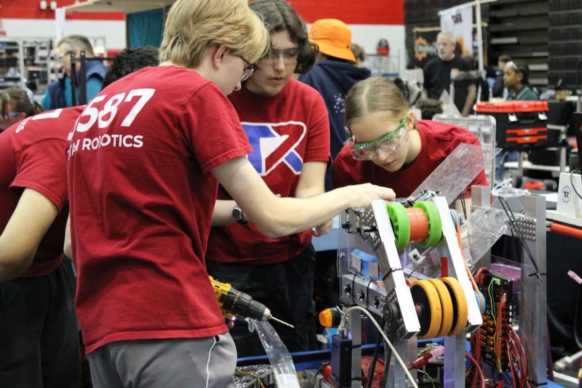 The Titan Robotics team tunes up their robot in preparation to compete at a recent event. 