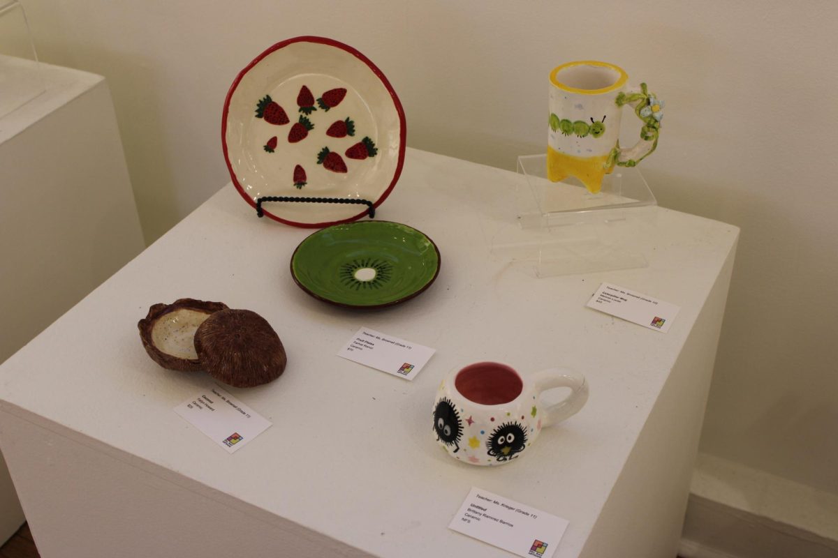 One of multiple tables displaying students ceramics creations at the exhibition. 