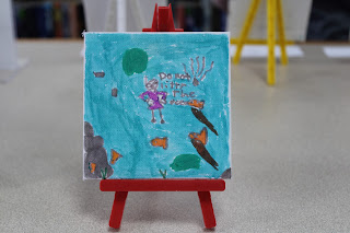 Canvas titled “The Ocean,” featuring a diver with marine life, painted by an eight year old artist. This painter shares, "I hope you guys know not to litter in the ocean.”
