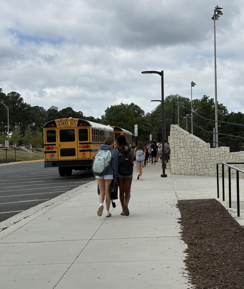 Students are walking to the busses to transition from the Minnie Howard campus to the King Street campus.